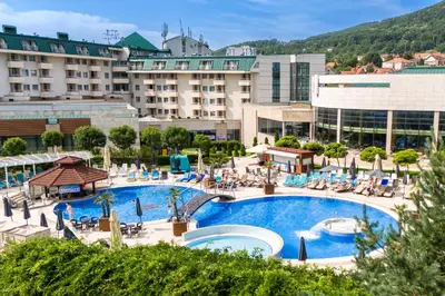 a hotel with a large swimming pool in a resort at A Hoteli - Hotel Izvor in Arandjelovac
