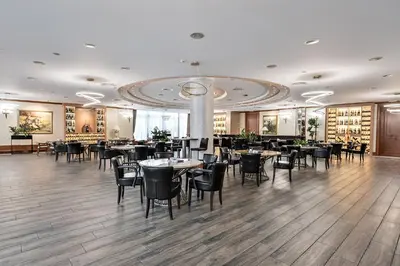 a restaurant with tables and chairs in a room at A Hoteli - Hotel Izvor in Arandjelovac