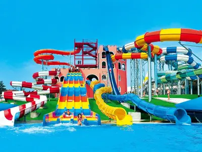 a water park with a water slide in the water at A Hoteli - Hotel Izvor in Arandjelovac