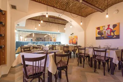 a restaurant with tables and chairs in a room at Capital Hotel Garni in Belgrade