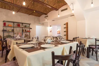 a dining room with white tables and chairs at Capital Hotel Garni in Belgrade