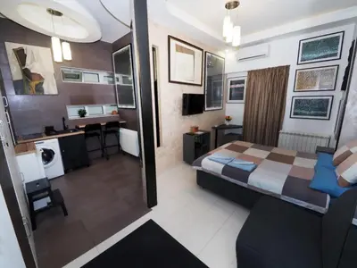 a hotel room with a bed and a bathroom at KennedyLux Apartment in Belgrade