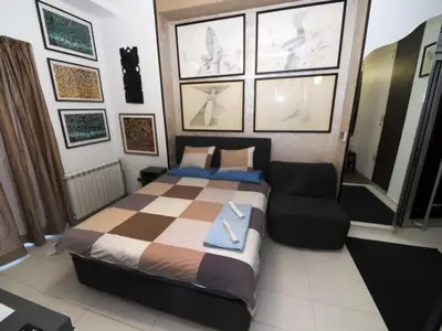 a bedroom with a bed and a couch at KennedyLux Apartment in Belgrade