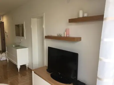 a living room with a flat screen tv on a wall at Apartment Posejdon in Belgrade