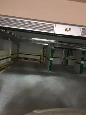 an empty parking garage with avertisementatronatronstrationstrationstrationstrationstrationstrationstration at Apartment Posejdon in Belgrade