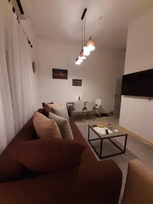 a living room with a couch and a table at Apartment Queen in Belgrade