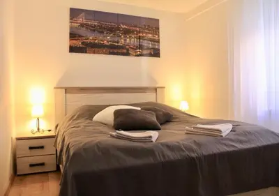 a bedroom with a bed with two towels on it at Apartment Queen in Belgrade