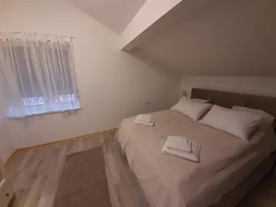 a bedroom with a bed with two towels on it at Apartment Queen in Belgrade