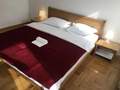 a bedroom with a large bed with two towels on it at Apartment Triton in Belgrade