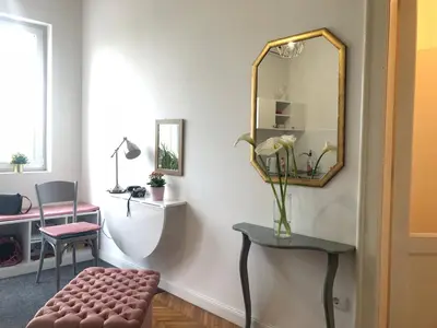 a living room with a mirror and a stool at Studio 50 with Terrace in Belgrade