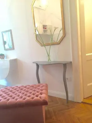 a stool in a room with a mirror and a table at Studio 50 with Terrace in Belgrade