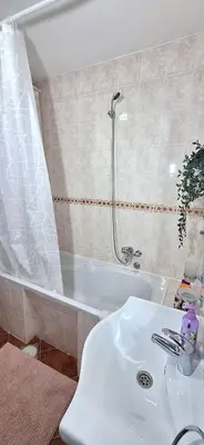 a bathroom with a sink and a shower and a tub at ANA Apartment in Dobanovci