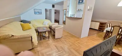 a living room with a bed and a dining room at ANA Apartment in Dobanovci