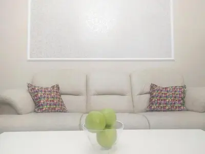 a living room with a couch and a bowl of apples at City Center Apartment MIKA in Belgrade