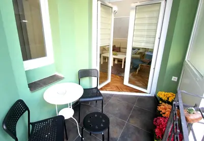 a small table and chairs in a small room with a table and a table at City Center Apartment MIKA in Belgrade