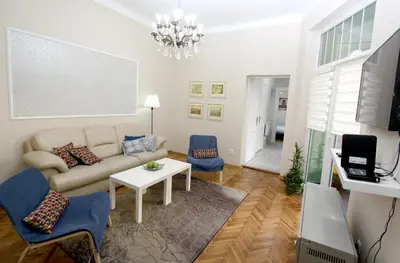 a living room with a couch and a table at City Center Apartment MIKA in Belgrade