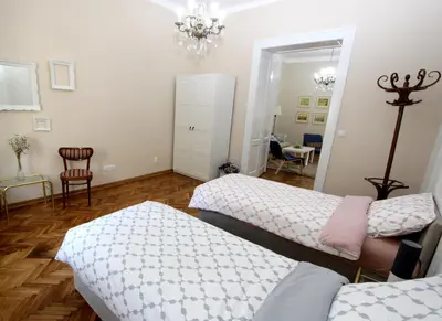 a living room with two beds and a dining room at City Center Apartment MIKA in Belgrade