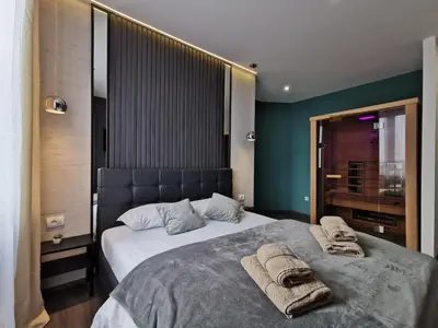 a bedroom with a large bed with towels on it at Marcel Apartments in Belgrade