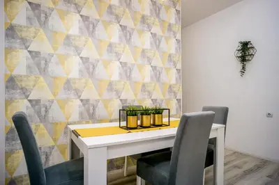 a dining room with a white table and chairs at Marcel Apartments in Belgrade