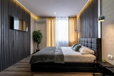 a bedroom with a large bed and a window at Marcel Apartments in Belgrade