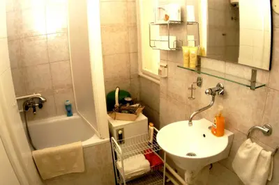a bathroom with a sink and a toilet and a shower at Bridge apartment in Belgrade