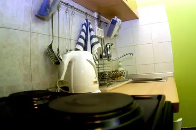 a kitchen counter with a toaster and utensils at Bridge apartment in Belgrade