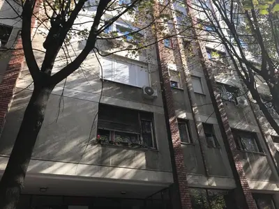 a building with a window with flowers in a window box at St. Sava Slavija Apartment in Belgrade