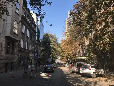 a city street with cars parked on the side of the road at St. Sava Slavija Apartment in Belgrade