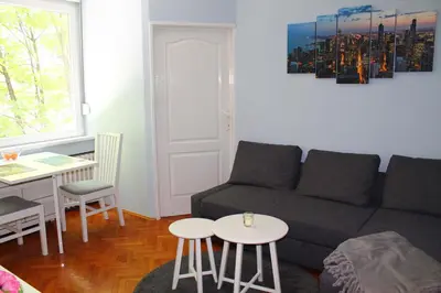 a living room with a couch and a table at St. Sava Slavija Apartment in Belgrade