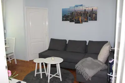 a living room with a couch and a table at St. Sava Slavija Apartment in Belgrade