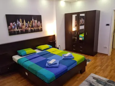 a bedroom with a large bed with towels on it at De Luxe Republic Square Apartment of 100sqm in Belgrade
