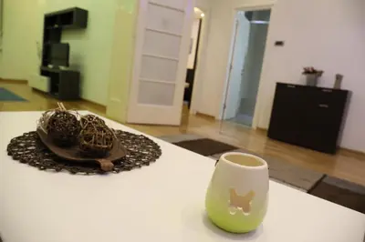 a pair of shoes and a cup on a table at De Luxe Republic Square Apartment of 100sqm in Belgrade