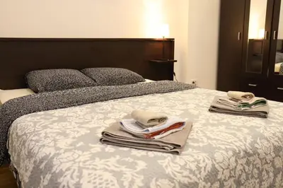 a bedroom with a bed with towels on it at De Luxe Republic Square Apartment of 100sqm in Belgrade