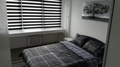 a bedroom with a bed in front of a window at WHITE CITY 2 in Belgrade