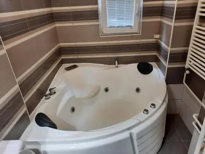 a white bath tub in a bathroom with a window at WHITE CITY 2 in Belgrade