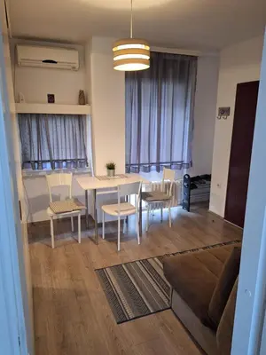a living room with a table and chairs and a couch at WHITE CITY 2 in Belgrade