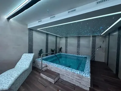 a bathroom with a large swimming pool with at Five Apartments in Inđija