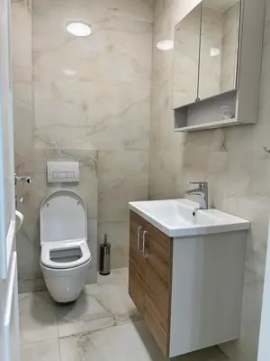 a bathroom with a toilet and a sink at Five Apartments in Inđija