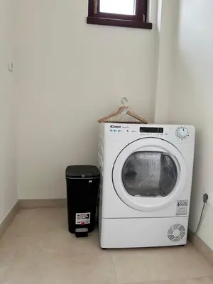 a washing machine and a trash can in a room at Five Apartments in Inđija