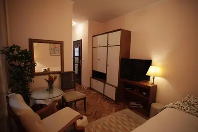 a living room with a couch and a television at Studio Hram in Belgrade
