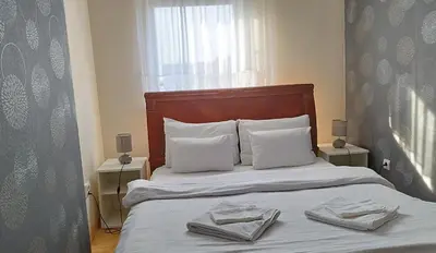 a bedroom with a bed with two towels on it at New Residence in Belgrade