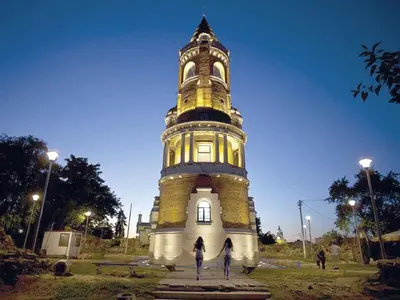 a tall tower with two people standing in front of it at New Residence in Belgrade