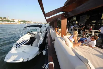 a group of people sitting on a boat in the water at New Residence in Belgrade