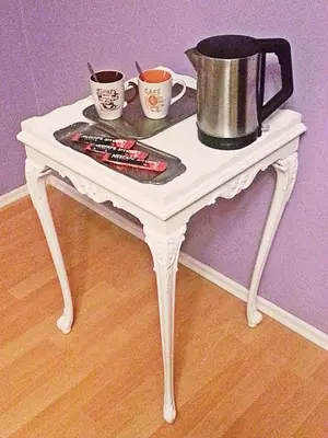 a white table with two cups and a pot on it at Bel Lion Serviced Suites in Belgrade