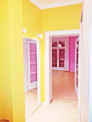 a room with yellow and purple walls at Bel Lion Serviced Suites in Belgrade