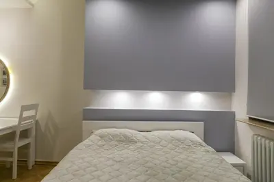 a bedroom with a bed and a table and a chair at Apartments Parlament in Belgrade