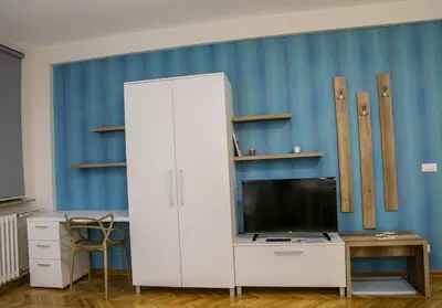 a white cabinet with a tv and a desk at Apartments Parlament in Belgrade