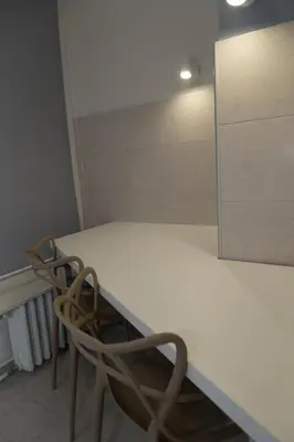 a room with a white table and a chair at Apartments Parlament in Belgrade