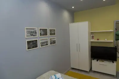 a living room with a tv and a white cabinet at Apartments Parlament in Belgrade