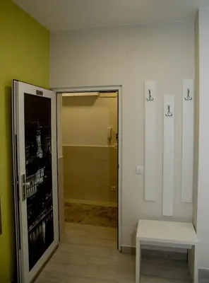 a room with a door to a bathroom with a bench at Apartments Parlament in Belgrade